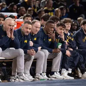 Sean Bormet with Assistant Coaches on Bench