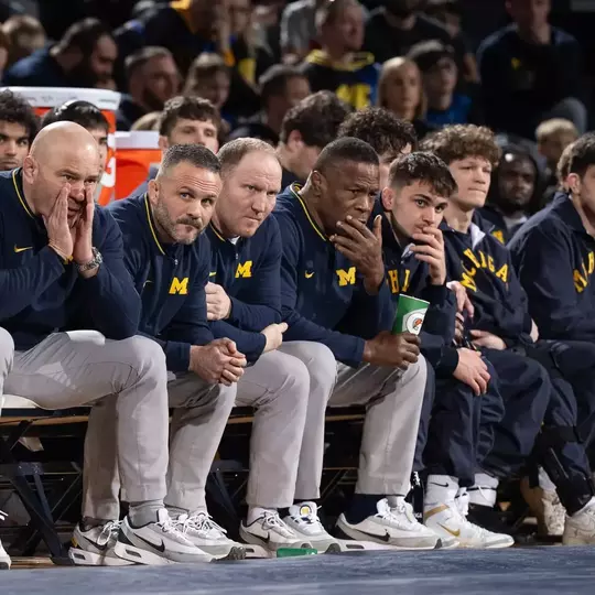 Sean Bormet with Assistant Coaches on Bench