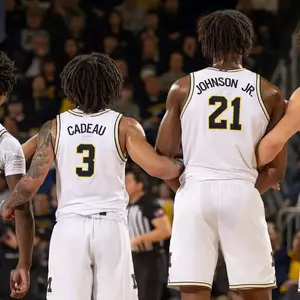 Men's basketball team huddle on the court