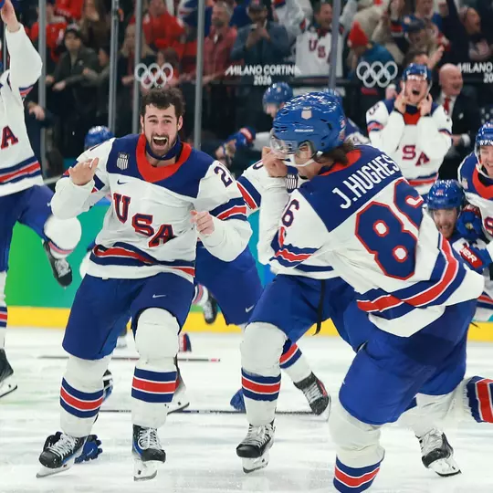 Dylan Larkin (#21 center) and players of Team United States celebrate a 2-1 victory against Canada in overtime for the gold medal during the Men's Gold Medal match between Canada and the United States on day 16 of the Milano Cortina 2026 Winter Olympic games at Milano Santagiulia Ice Hockey Arena on February 22, 2026 in Milan, Italy (Getty Images)