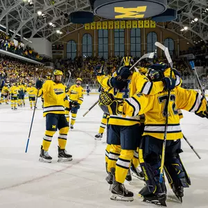 Ice hockey team celebration on the ice at Yost Ice Arena