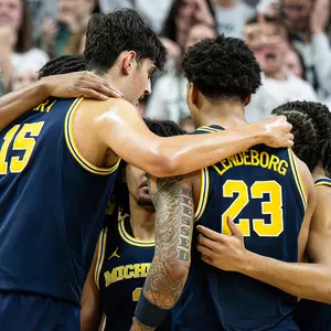 Men's basketball on-court team huddle