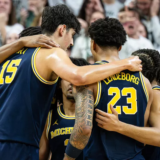 Men's basketball on-court team huddle