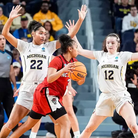 Kendall Dudley (22) and guard Syla Swords (12) defend NC State guard Zamareya Jones (3) during the first half of NCAA Tournament Second Round at Crisler Center in Ann Arbor on Sunday, March 22, 2026. (Imagn Images)