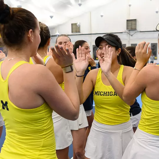 Women's tennis team celebration on-court