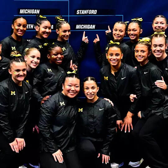 Women's Gymnastics Poses in Front of Regional Bracket