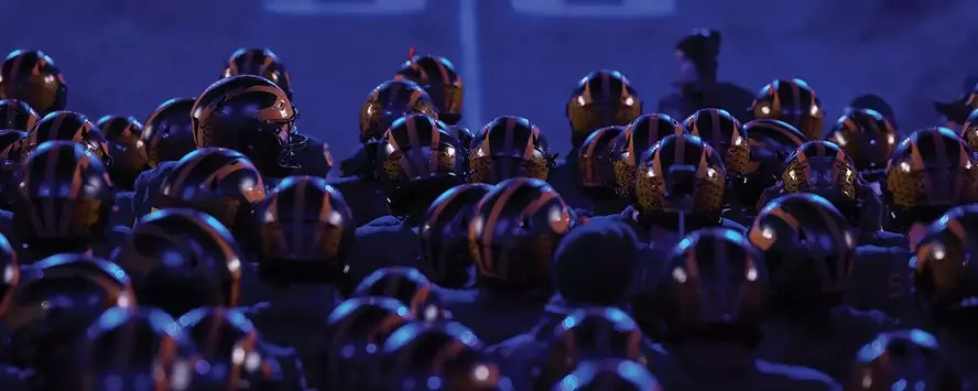 Michigan football team walking onto the field at night