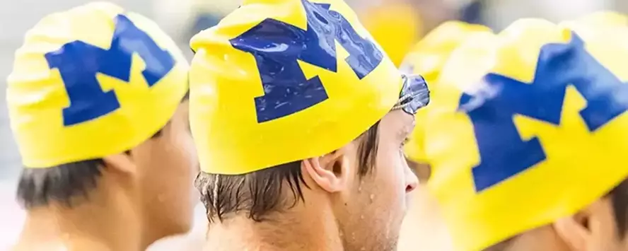 Maize Michigan swim caps with the Block M