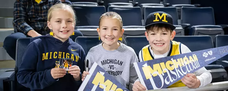 Kids with Michigan basketball pennants