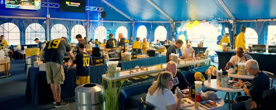 Fans enjoying the UMCU All-Star Lounge at a Michigan Football game
