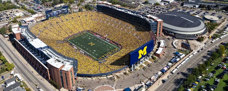 Aerial photo of Michigan Stadium during the day and a maize out