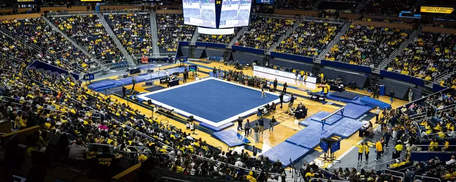Crisler Center with floor set up for women's gymnastics meet and fans in the stands