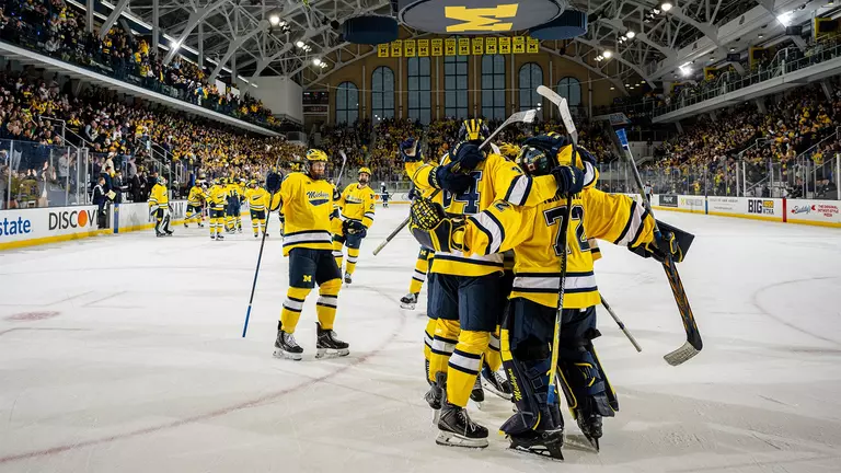 Michigan ice hockey postgame win celebration on ice
