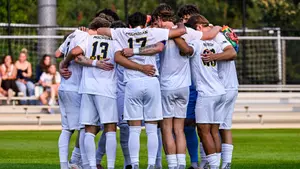 Men's soccer team huddle