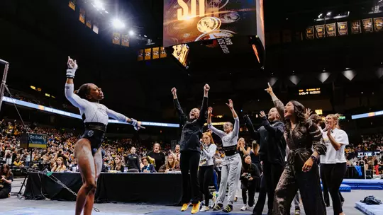 Hannah Horton celebrates with the Mizzou gymnastics team after sticking her bars routine at the Mizzou Quad on Feb. 20, 2026.