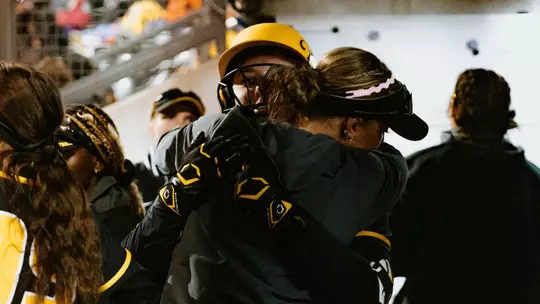 Freshman Sidney Forrester gets a hug in the dugout after hitting a home run to centerfield against USD