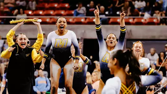 Members of the Mizzou gymnastics team cheer on Kennedy Griffin during her floor routine at Auburn on March 13, 2026.