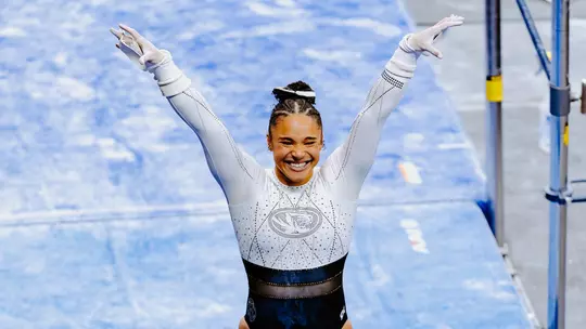 Mizzou gymnast Makayla Green celebrating after completing her uneven bars routine at the Mizzou Quad on Feb. 20, 2026.