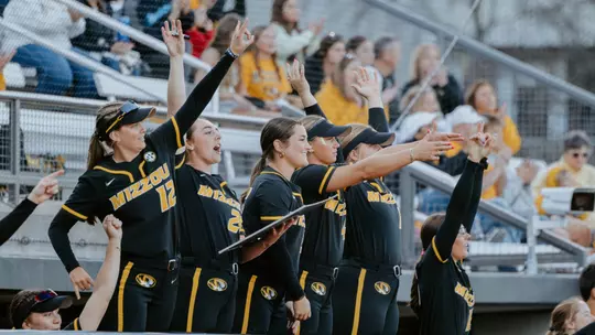 The Mizzou softball dugout celebrates as the Tigers get a hit against Drake at the Mizzou Invitational