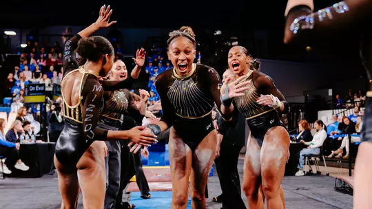 Freshman Kimarra Echols celebrates with the Mizzou gymnastics team after her vault at Kentucky on Feb. 13, 2026.