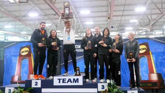 women's fencers and coaches with fourth place trophy