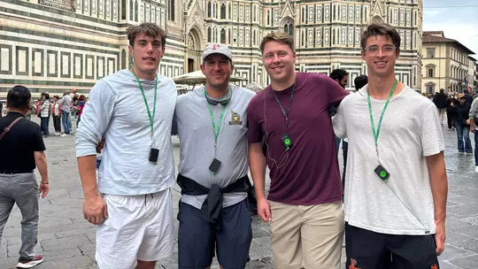Owen Fischer, Matt Madalon, Drew Cottrell and Wilder Burgin stand in front of a cathedral in Florence, Italy