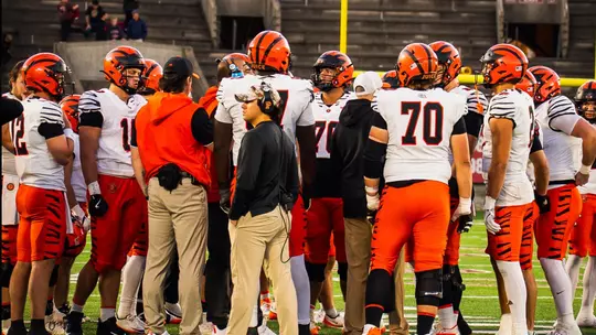 Football gathers on the field at Harvard Stadium in 2026