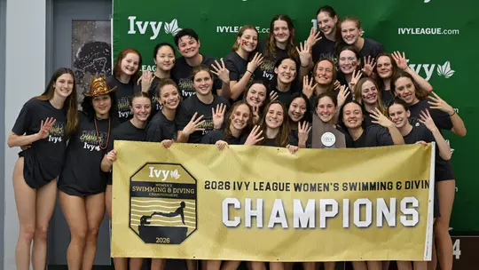 Women's Swimming & Diving with trophy and banner