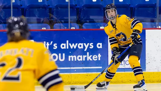 Kahlen Lamarche passing the puck to Jade Barbirati against Dartmouth (1.16.26 in Hamden, C.T.)