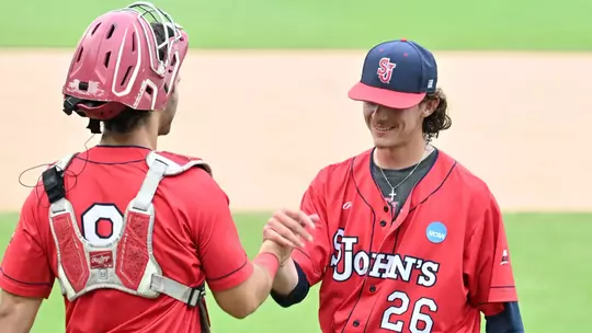 Nick Romer and Adam Agresti after securing the victory. Romer closed out the game for the Johnnies with a pair strikeouts in a scoreless ninth