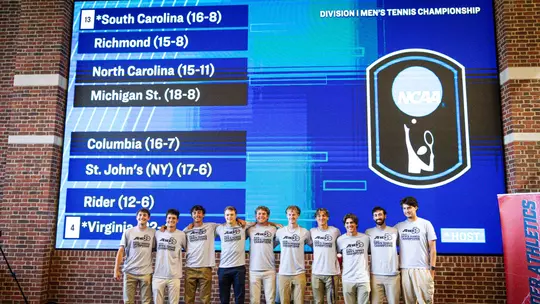 Men's Tennis in front of tournament bracket