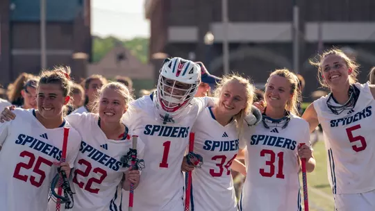 WLAX Team members smile after defeating Davidson 16-7