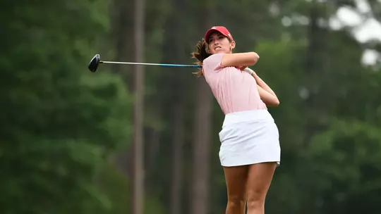 Katie Magner grimaces as she hits a drive