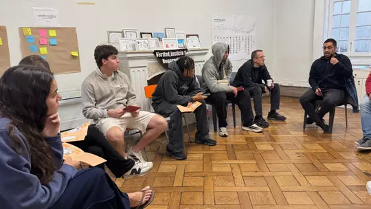 A group of students meet in a circle on a trip to Chile