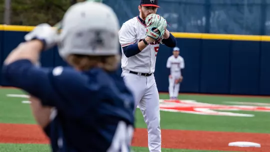 Joey Giordano looks over his glove before throwing the ball.