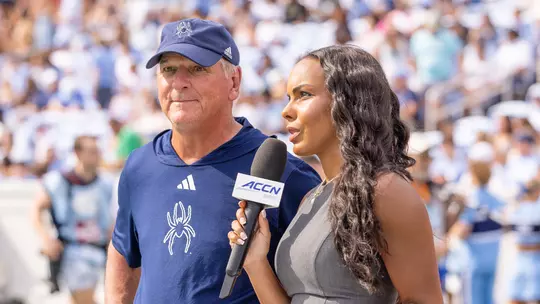 Russ Huesman doing sideline interview at North Carolina