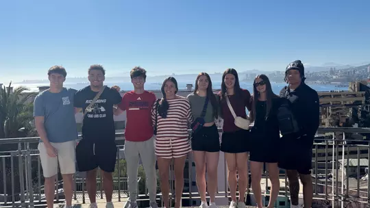 Spider student-athletes pose on an overlook in Chile