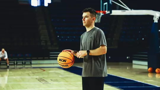 Quinn Harmon prepares to throw a pass in the Robins Center