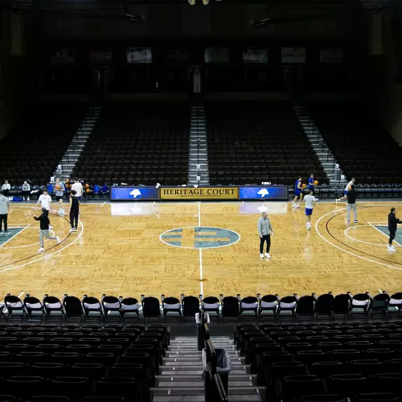 A picture with men's basketball players shooting basketball's on the Sanford Pentagon basketball court