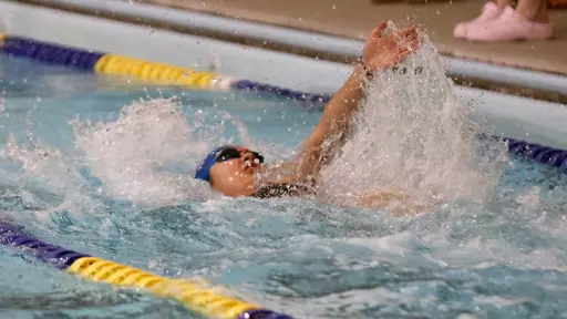 A South Dakota State women's swimmer competes in the backstroke.