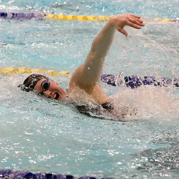 Jenna Currier swims freestyle in home action.