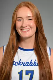 A volleyball player in white poses for her headshot