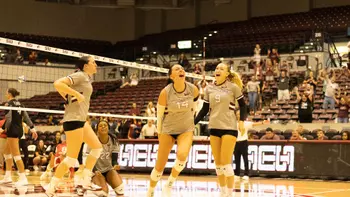 The team jumps and celebrates after winning the match.