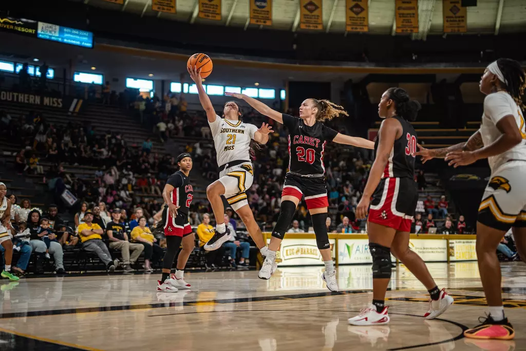 Carly Keats drives to the basket against William Carey
