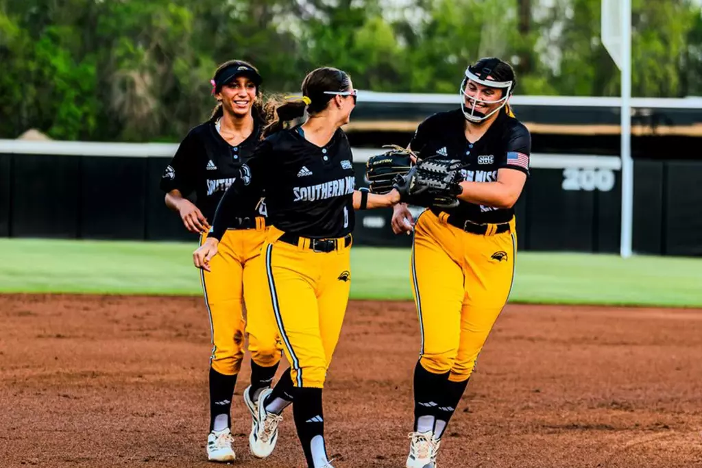 Kinsley Gordon-Sivley, Madison Johnson, and Madilyn Graham between innings