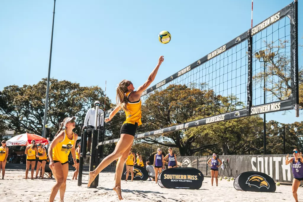 Sadie McAda (15) watches Laurel Dennis (4) attack the net