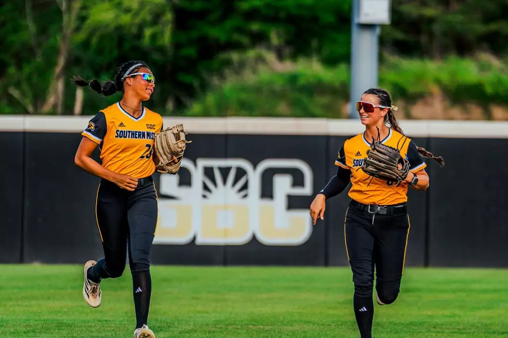 Kinsley Gordon-Sivley and Adryan Cox running in after the inning