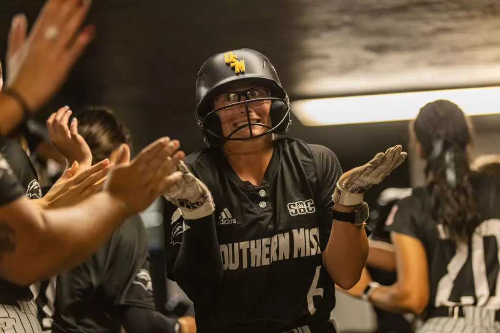 Kinsley Gordon-Sivley celebrating in dugout