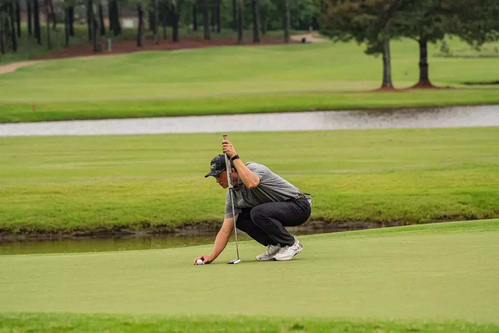 Matthew Javier lining up a putt