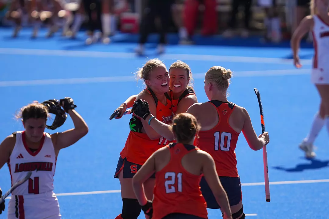 Syracuse field hockey celebrates a goal against Louisville